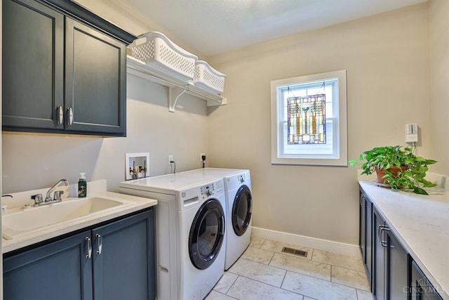 1439 Legacy Ct, Troy, OH 45373 - laundry area featuring cabinet space, washing machine and clothes dryer, and light tile patterned floors