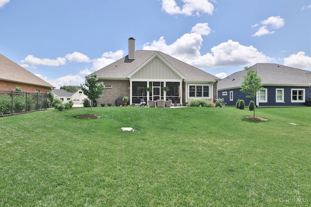 1439 Legacy Ct, Troy, OH 45373 - back of house featuring a chimney, a sunroom, board and batten siding, and roof with shingles