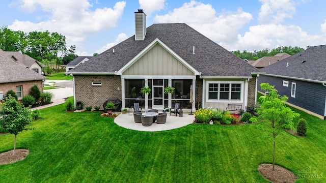 1439 Legacy Ct, Troy, OH 45373 - back of property with board and batten siding, brick siding, a patio, a lawn, and a chimney