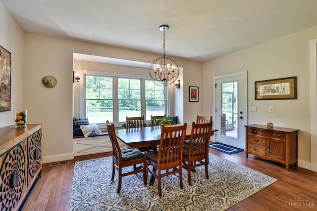 1439 Legacy Ct, Troy, OH 45373 - dining area with healthy amount of natural light, wood finished floors, and a chandelier