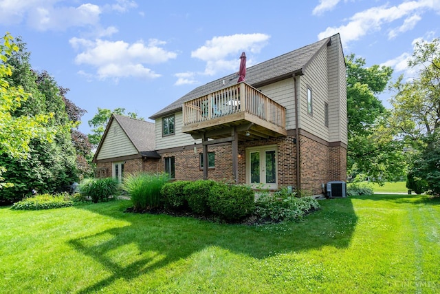 501 Tara Oaks Dr, Middletown, OH 45042 - rear view of house with a lawn, brick siding, a deck, and a shingled roof