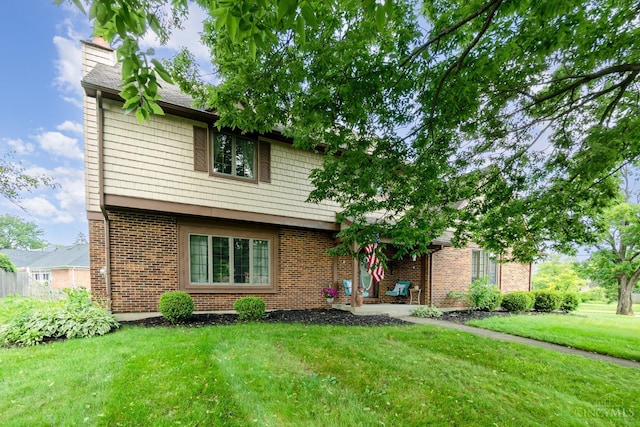 501 Tara Oaks Dr, Middletown, OH 45042 - view of front of house with a front yard, brick siding, and a chimney