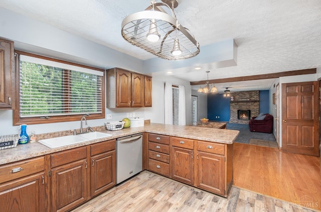 501 Tara Oaks Dr, Middletown, OH 45042 - kitchen with dishwasher, a textured ceiling, light countertops, a peninsula, and brown cabinets