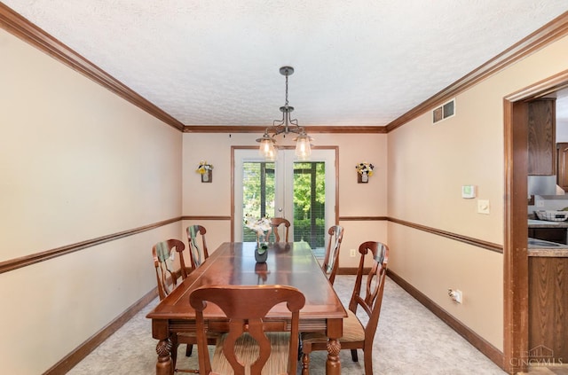 501 Tara Oaks Dr, Middletown, OH 45042 - dining area featuring french doors, a textured ceiling, ornamental molding, and light colored carpet