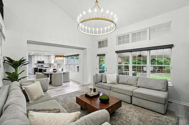 4870 Highland Oaks Dr, Green Twp, OH 45248 - living area featuring a chandelier, light wood-style flooring, and a high ceiling