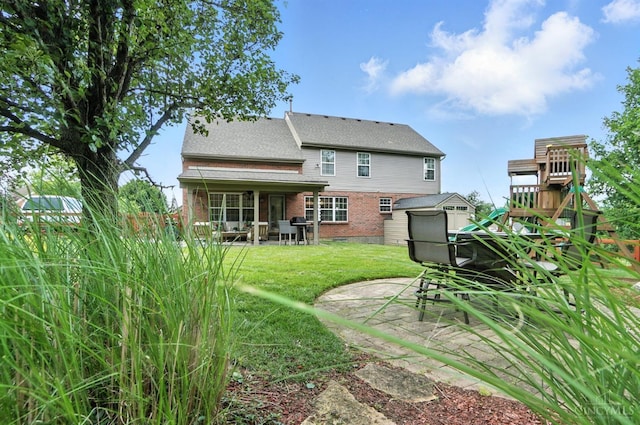 4870 Highland Oaks Dr, Green Twp, OH 45248 - rear view of house with brick siding, a patio, a yard, a shed, and a playground