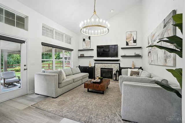 4870 Highland Oaks Dr, Green Twp, OH 45248 - living area featuring a chandelier, wood finished floors, high vaulted ceiling, and a fireplace