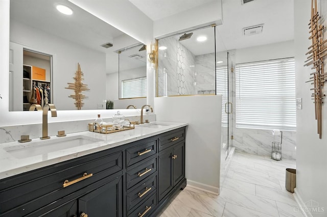 4870 Highland Oaks Dr, Green Twp, OH 45248 - full bathroom featuring marble look tile flooring, a marble finish shower, double vanity, and healthy amount of natural light