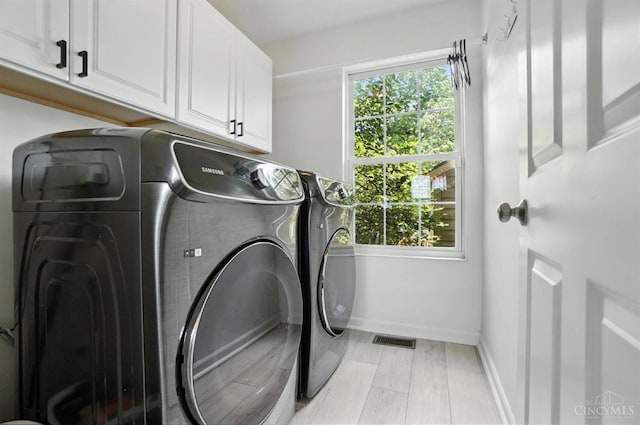 4870 Highland Oaks Dr, Green Twp, OH 45248 - laundry area featuring cabinet space and washing machine and clothes dryer