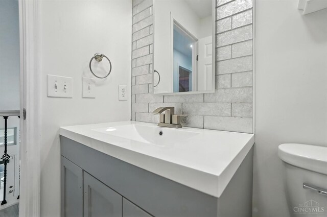 4870 Highland Oaks Dr, Green Twp, OH 45248 - bathroom featuring vanity and decorative backsplash