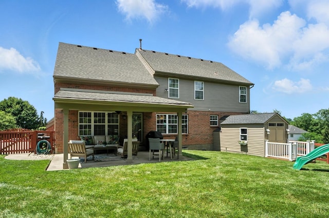 4870 Highland Oaks Dr, Green Twp, OH 45248 - back of house featuring a patio, an outdoor hangout area, brick siding, roof with shingles, and a shed
