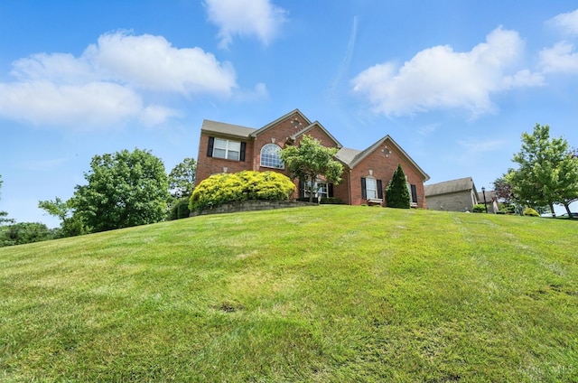 4870 Highland Oaks Dr, Green Twp, OH 45248 - traditional-style house featuring brick siding and a front yard