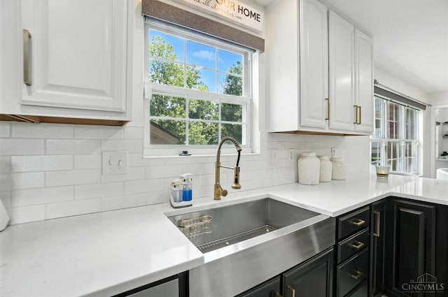 4870 Highland Oaks Dr, Green Twp, OH 45248 - kitchen featuring white cabinetry, dark cabinetry, light countertops, and decorative backsplash