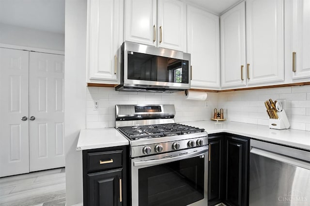 4870 Highland Oaks Dr, Green Twp, OH 45248 - kitchen with appliances with stainless steel finishes, white cabinetry, light countertops, and dark cabinets