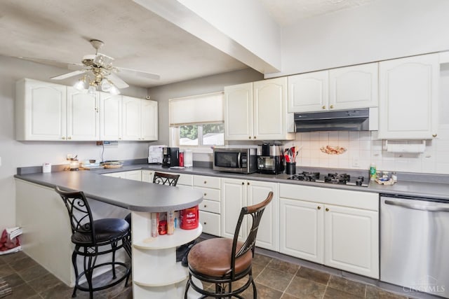 197 Millville, Hamilton, OH 45013 - kitchen featuring appliances with stainless steel finishes, under cabinet range hood, a kitchen breakfast bar, and white cabinetry