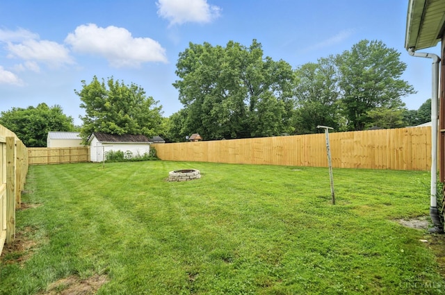 668 Shawhan Rd, Union Twp, OH 45065 - fenced backyard featuring an outdoor fire pit and a storage unit