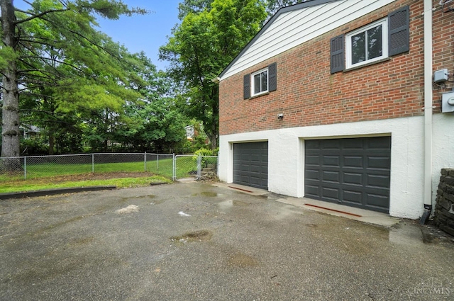 2000 Neeb Rd, Green Twp, OH 45233 - view of side of property featuring asphalt driveway, an attached garage, and brick siding