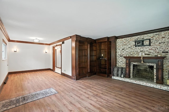 2000 Neeb Rd, Green Twp, OH 45233 - unfurnished living room with wood finished floors, crown molding, and a fireplace with raised hearth