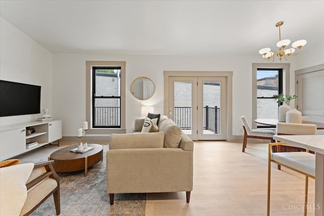 1431 Republic St Unit 3, Cincinnati, OH 45202 - living area featuring a chandelier, plenty of natural light, and light wood-style flooring