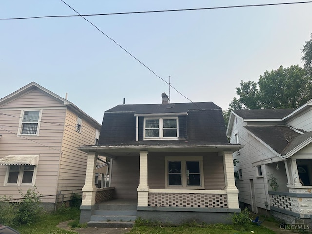 1812 Carroll Ave, Middletown, OH 45042 - colonial inspired home featuring a porch, a chimney, brick siding, and a gambrel roof
