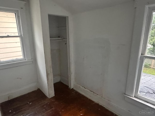 1812 Carroll Ave, Middletown, OH 45042 - unfurnished bedroom featuring a closet, multiple windows, wood finished floors, and vaulted ceiling