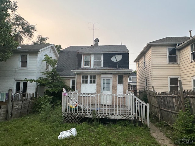 1812 Carroll Ave, Middletown, OH 45042 - back of house featuring brick siding, a deck, a chimney, and a shingled roof