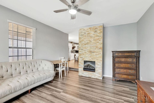 711 Van Roberts Pl, Wyoming, OH 45215 - living area featuring a ceiling fan, wood finished floors, and a fireplace