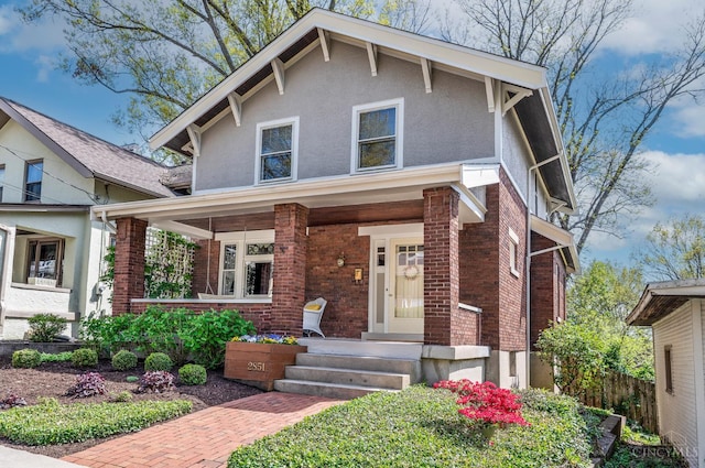 2851 Pine Grove Ave, Cincinnati, OH 45208 - view of front of house featuring brick siding, a porch, and stucco siding