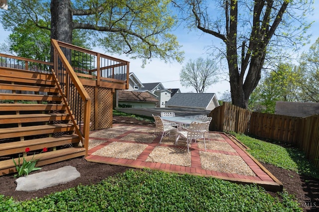 2851 Pine Grove Ave, Cincinnati, OH 45208 - fenced backyard with a wooden deck, a patio area, stairway, and outdoor dining space