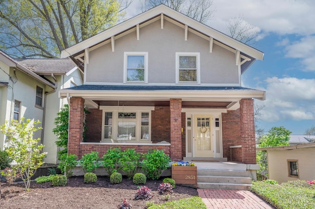 2851 Pine Grove Ave, Cincinnati, OH 45208 - view of front of property featuring covered porch, brick siding, and stucco siding