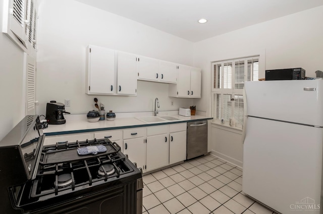 2851 Pine Grove Ave, Cincinnati, OH 45208 - kitchen featuring freestanding refrigerator, stainless steel dishwasher, black range with gas cooktop, white cabinets, and light countertops