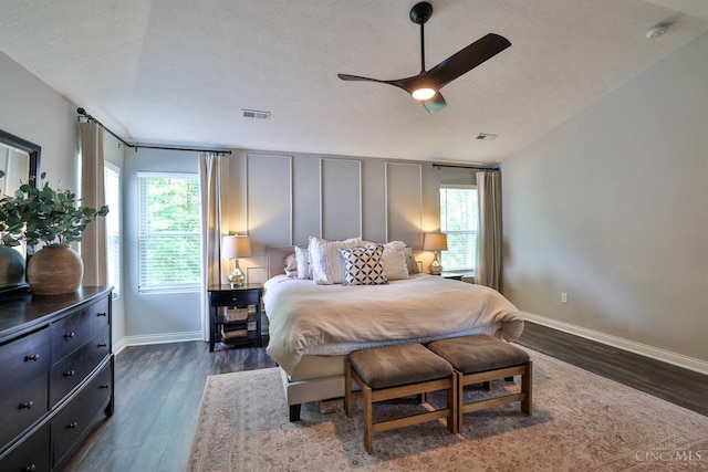 6352 Copperleaf Ln, Miami Twp, OH 45140 - bedroom featuring multiple windows, dark wood finished floors, a textured ceiling, and a ceiling fan