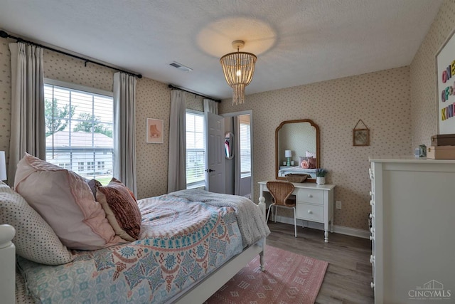 6352 Copperleaf Ln, Miami Twp, OH 45140 - bedroom with wood finished floors, multiple windows, and wallpapered walls