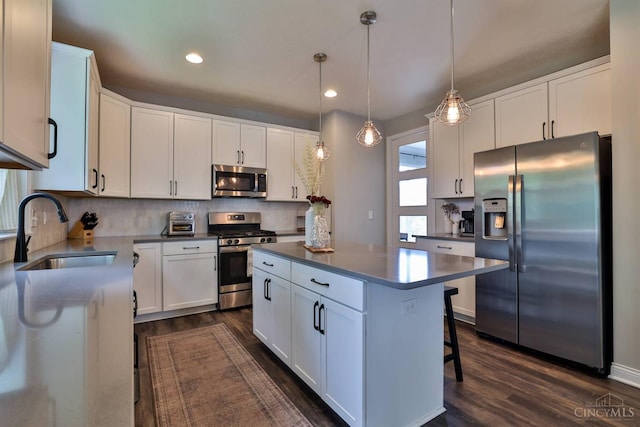 6352 Copperleaf Ln, Miami Twp, OH 45140 - kitchen featuring appliances with stainless steel finishes, dark wood-style flooring, white cabinets, recessed lighting, and decorative backsplash