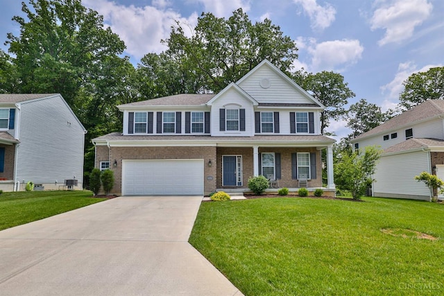 6352 Copperleaf Ln, Miami Twp, OH 45140 - view of front of home with driveway, a garage, a front yard, a porch, and brick siding