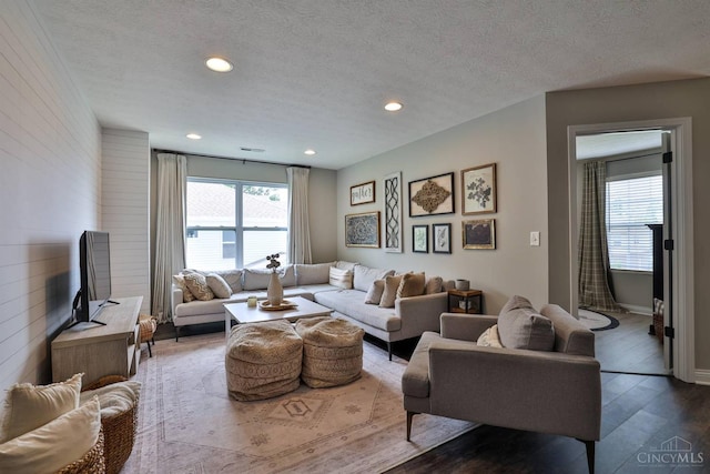 6352 Copperleaf Ln, Miami Twp, OH 45140 - living room featuring wood finished floors, recessed lighting, wood walls, and a textured ceiling