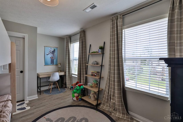 6352 Copperleaf Ln, Miami Twp, OH 45140 - recreation room with wood finished floors, a desk, and a textured ceiling