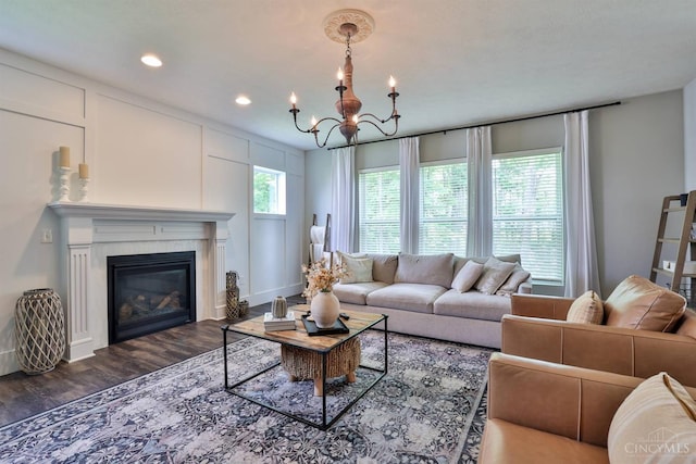 6352 Copperleaf Ln, Miami Twp, OH 45140 - living area with wood finished floors, a chandelier, recessed lighting, and a glass covered fireplace