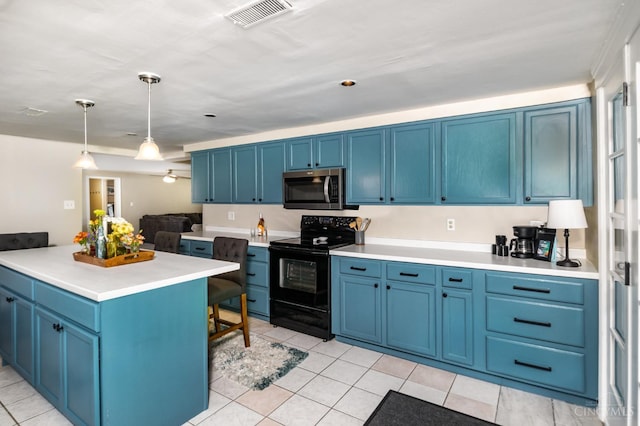 4 Brooklyn Ln, Miami Twp, OH 45150 - kitchen with black range with electric cooktop, stainless steel microwave, blue cabinets, light tile patterned floors, and light countertops