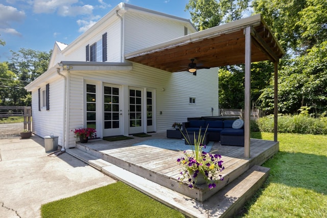 4 Brooklyn Ln, Miami Twp, OH 45150 - back of property featuring a ceiling fan, a deck, an outdoor living space, a lawn, and a hot tub