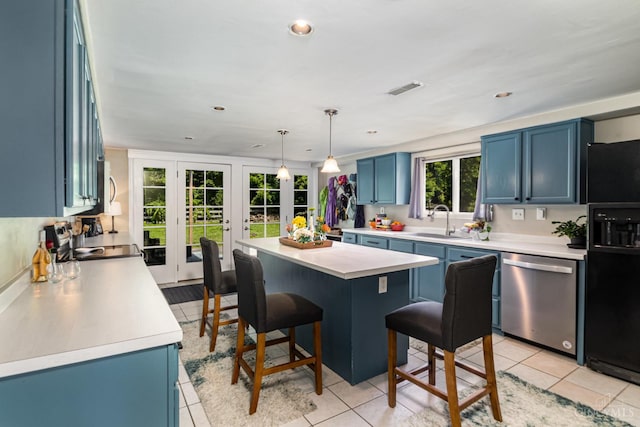 4 Brooklyn Ln, Miami Twp, OH 45150 - kitchen with stainless steel appliances, blue cabinets, a kitchen bar, light countertops, and french doors