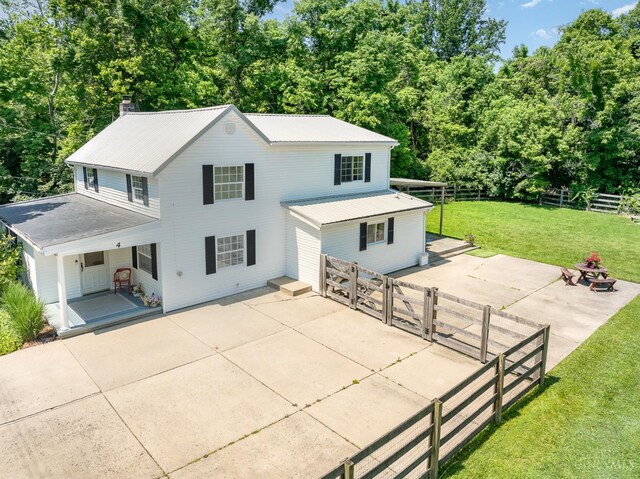 4 Brooklyn Ln, Miami Twp, OH 45150 - back of property with a patio, a fenced backyard, a chimney, and a metal roof