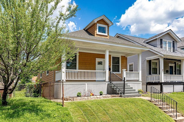 3104 Celeron Ave, Cincinnati, OH 45209 - view of front facade with a shingled roof, a porch, a front lawn, and stairway