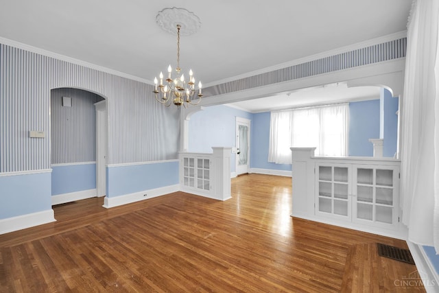 3459 Alta Vista Ave, Cheviot, OH 45211 - spare room featuring arched walkways, crown molding, wood finished floors, and a chandelier