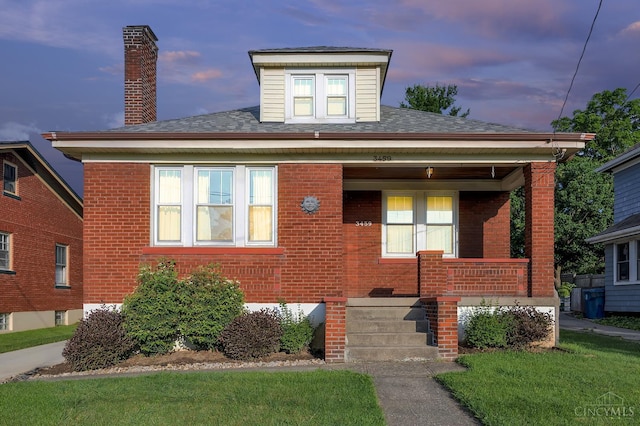 3459 Alta Vista Ave, Cheviot, OH 45211 - bungalow-style house featuring brick siding, covered porch, a chimney, and a shingled roof