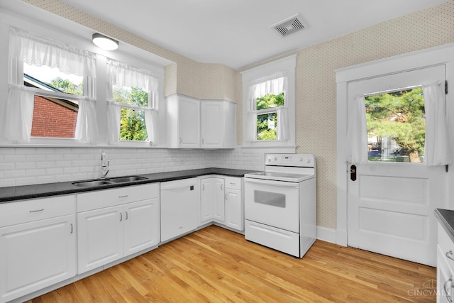 3459 Alta Vista Ave, Cheviot, OH 45211 - kitchen featuring white appliances, wallpapered walls, dark countertops, and plenty of natural light