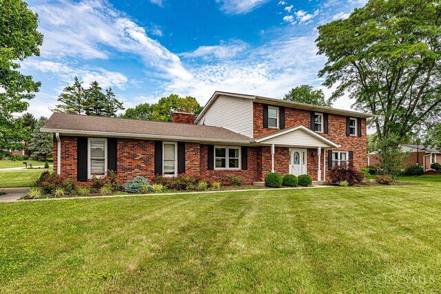 2974 Acer Ct, Ross Twp, OH 45013 - traditional-style home featuring a front lawn, brick siding, and a chimney