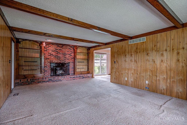 2974 Acer Ct, Ross Twp, OH 45013 - unfurnished living room with a textured ceiling, wooden walls, beamed ceiling, and carpet flooring