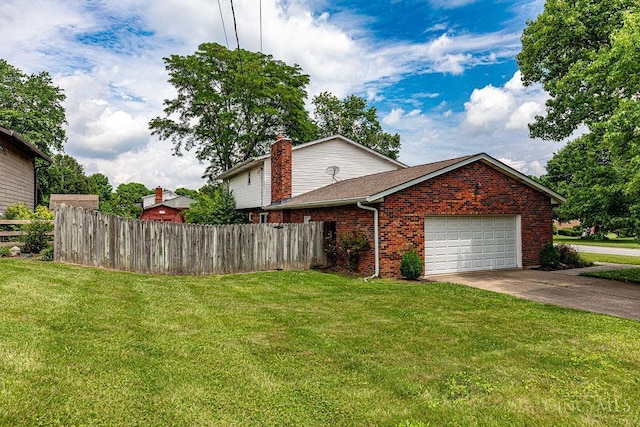 2974 Acer Ct, Ross Twp, OH 45013 - view of home's exterior featuring a garage, brick siding, driveway, and a chimney