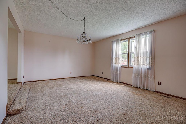 2974 Acer Ct, Ross Twp, OH 45013 - unfurnished room featuring a chandelier, carpet flooring, and a textured ceiling